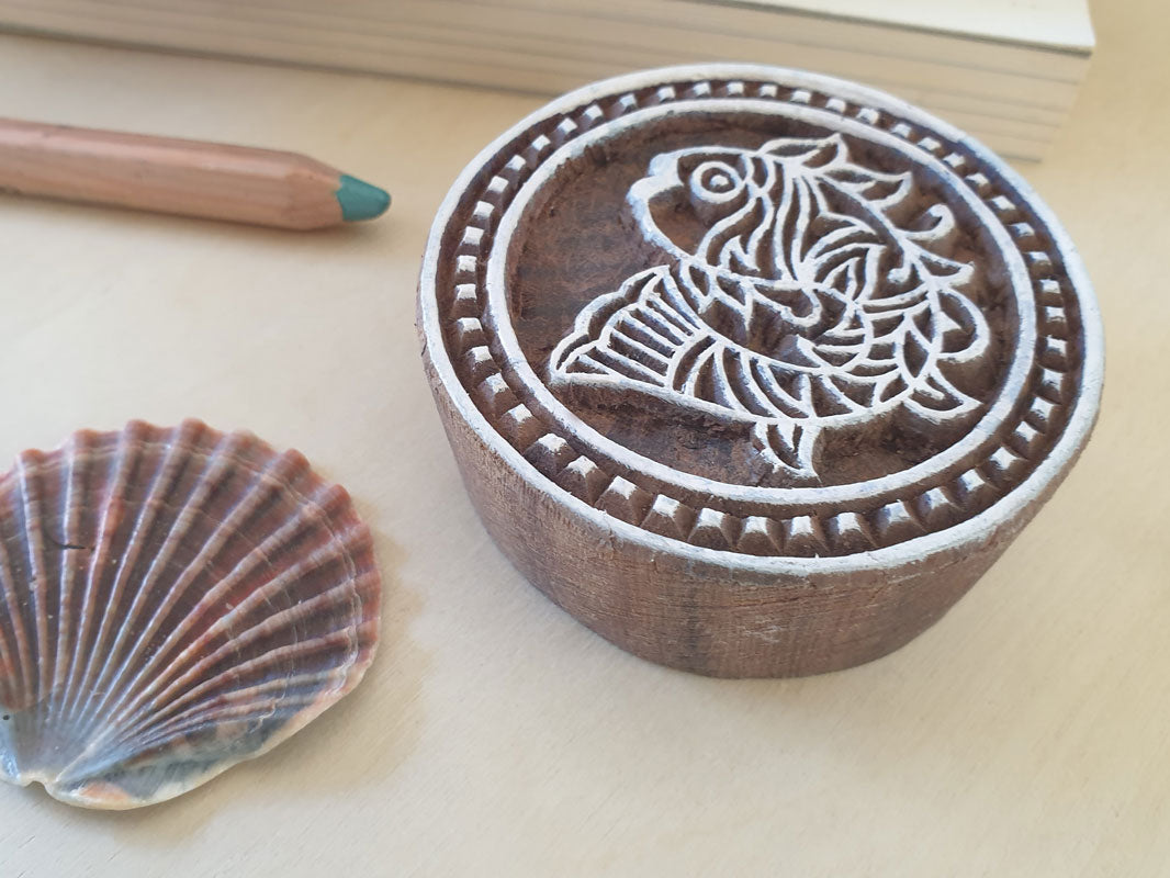 round fish stamp.